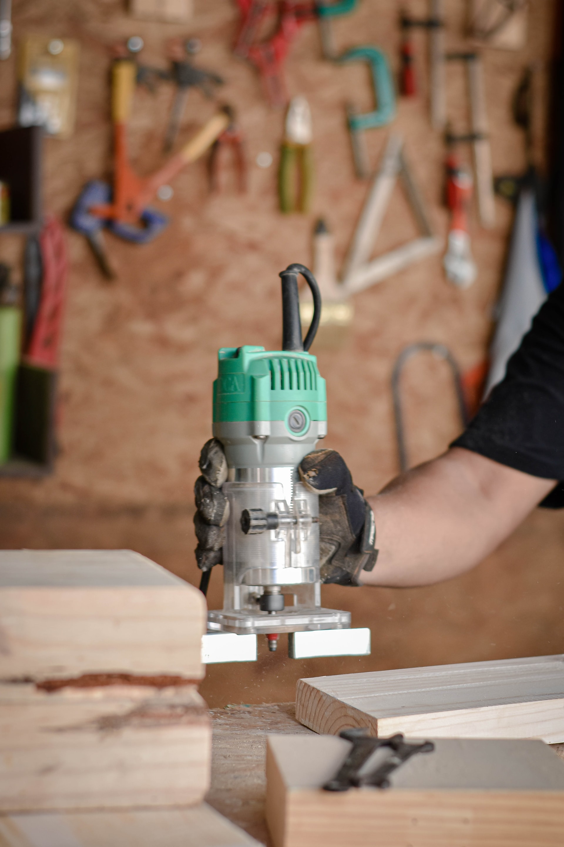 person holding green and gray power tool